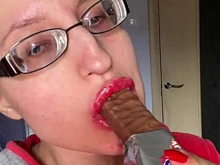 giantess with big lips and eyeglasses contrasts huge tall fetish while eating snickers protein bar
