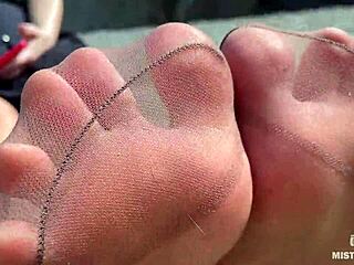 Goddess contrasts tan nylons with cute soles and toes teasing by the riverside outdoors