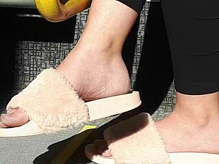 look at this candid shoeplay from a stunning brunette in pink slides on the train