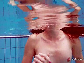 Martina shows off her tight pussy in a blue bikini during an underwater swim at the pool.