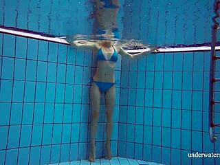 Martina shows off her tight pussy in a blue bikini during an underwater swim at the pool.